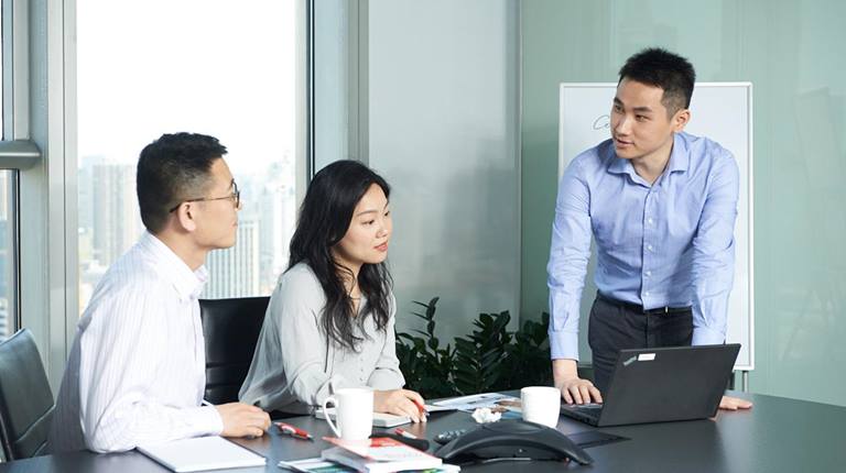 Three employees at desk